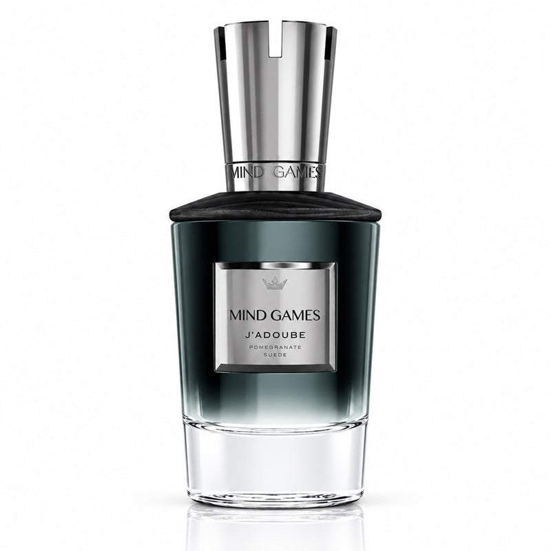 A bottle of J'ADQUIRE MIND GAMES Pomegranate London fragrance, featuring a dark green-to-clear gradient glass bottle with a polished silver cap and a silver label.