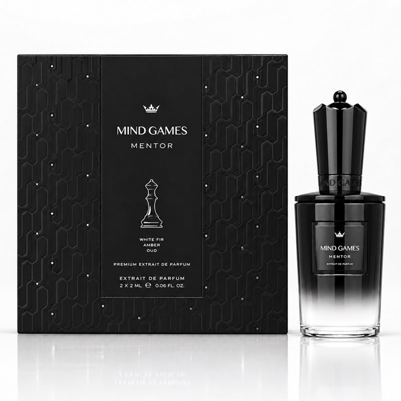 MIND GAMES Mentor White Fir Amber oud premium extrait de parfum, showing the black patterned retail box and the black-to-clear gradient perfume bottle on a white reflective surface.