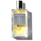 A rectangular glass bottle of L'Envers du Paradis perfume by Mizensir, with a clear yellow liquid visible inside and a black cap. The label features the brand name and the product name in elegant typography.