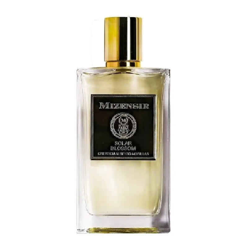Perfume bottle with gold cap and visible brand name on a white background