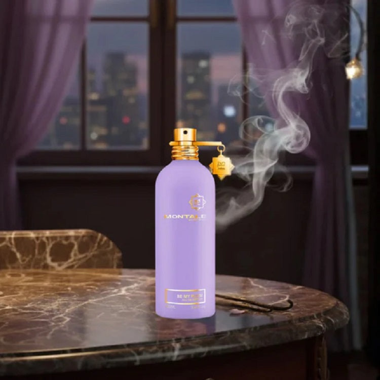 Purple Montale perfume bottle with gold cap on a marble table with cityscape background