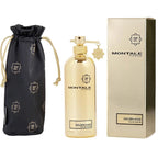 Gold perfume bottle with packaging and black drawstring bag on white background