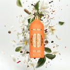 Montale Paris perfume bottle surrounded by flowers and leaves on a light background