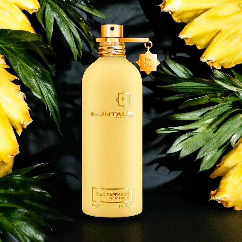 Montale perfume bottle with yellow flowers and green leaves on a dark background