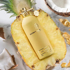 Montale perfume bottle on a pineapple slice with coconut pieces in the background