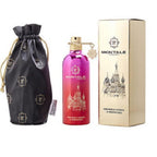Montale perfume bottle and box for 'Rendez-vous a Paris' Eau De Parfum. The bottle is pink with gold details and the box is gold with a print of a building.
