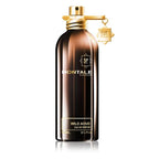 A brown bottle of Montale Wild Aoud Eau de Parfum with a gold spray nozzle and a small gold keychain attached to it.
