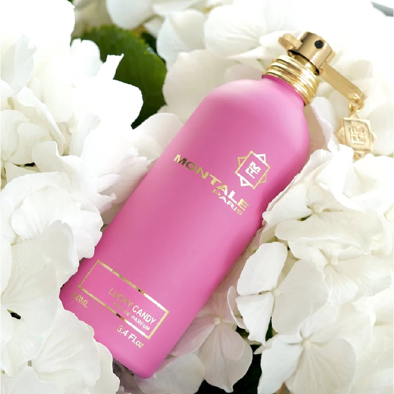 Pink Montale Paris perfume bottle on white flowers
