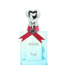 A bottle of Moschino Funny Eau de Toilette with a clear glass container, blue liquid, and a decorative red ribbon with a heart-shaped stopper.