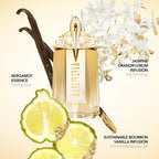 Perfume bottle with vanilla bean, lime, and flowers on a beige background