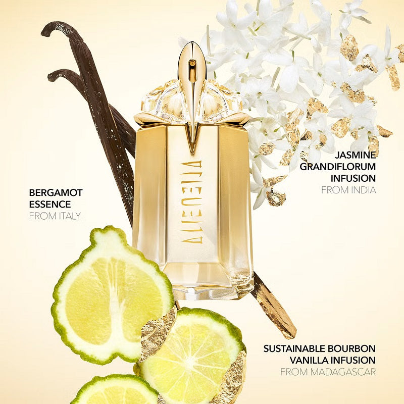Perfume bottle with vanilla bean, lime, and flowers on a beige background