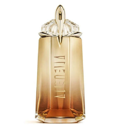 Gold perfume bottle with a decorative cap on a white background