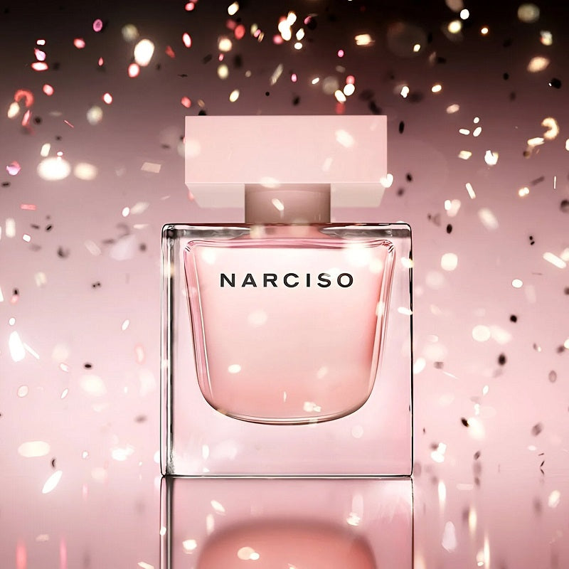 Perfume bottle with pink confetti on a soft pink background