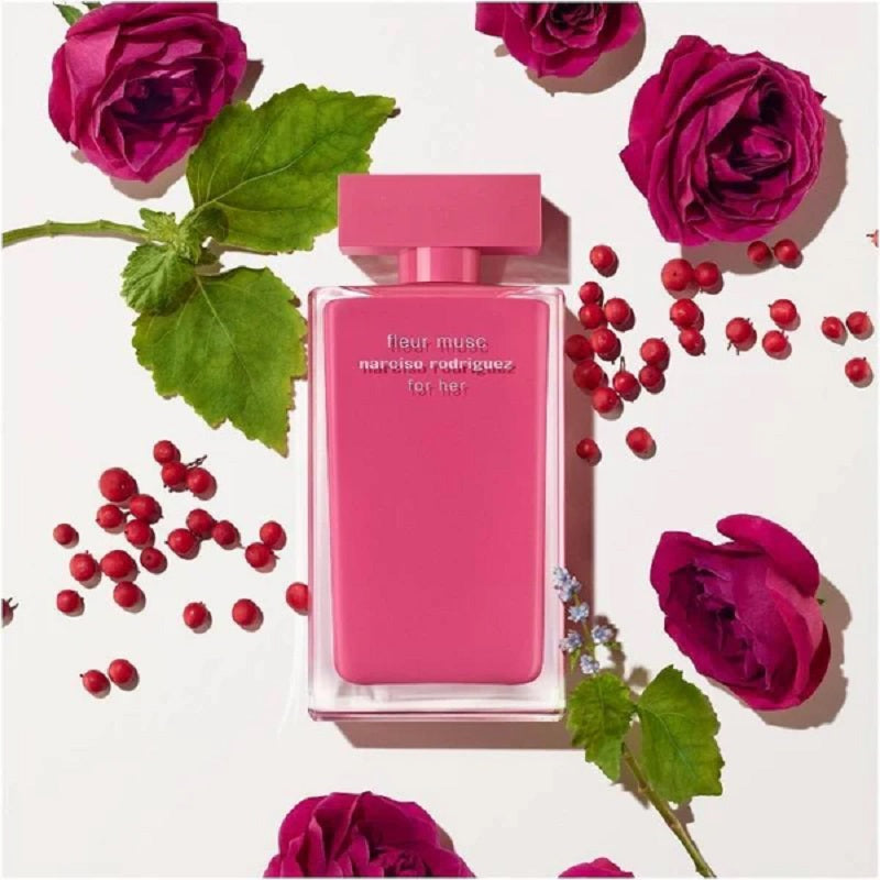 Pink perfume bottle with roses and berries on a white background