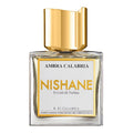 A square-shaped glass bottle of Ambra Calabria Extrait de Parfum by Nishane with a clear label and a gold-colored cap.