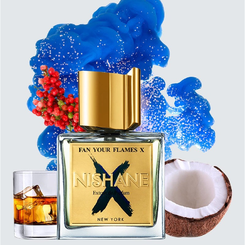 Nishane perfume bottle with blue smoke, berries, a glass of alcohol, and a coconut on a light gray background.