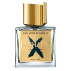 A bottle of Fan Your Flames X Extrait de Parfum by Nishane, with a gold cap and a label featuring the product name and brand.
