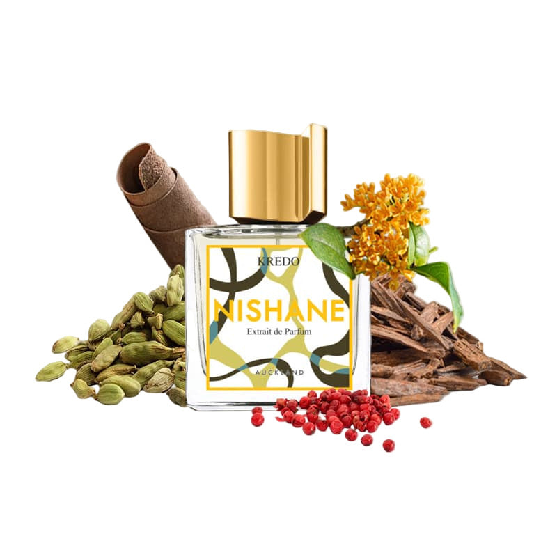 Nishane perfume bottle with cardamom, pepper, and flowers on a beige background