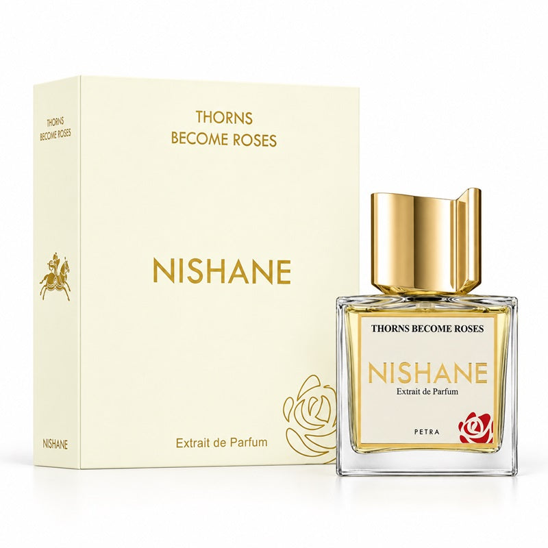 Nishane Thorns Become Roses Extrait de Parfum bottle with a gold cap next to its cream-colored packaging box, on a white background.