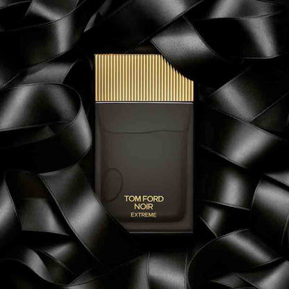 Tom Ford Noir Extreme perfume bottle on a black textured background