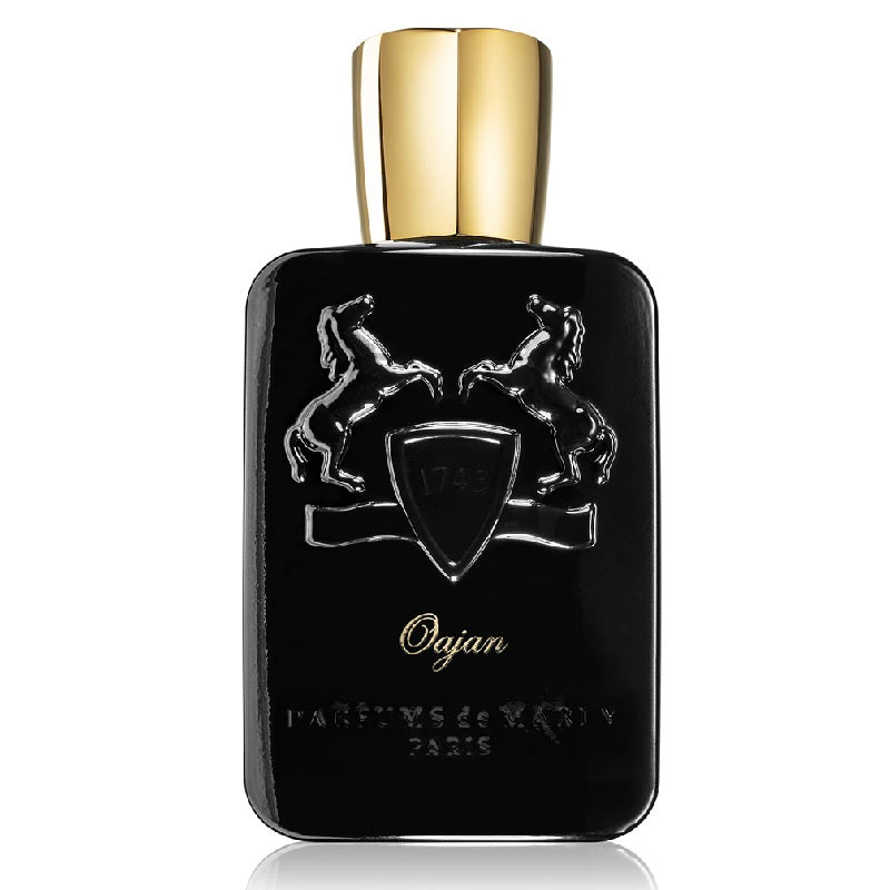 A black bottle of Oajan Royal Essence Eau de Parfum by Parfums de Marly with a gold cap, featuring an engraved emblem on the front.