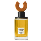 A bottle of Marque-Page Eau de Parfum by Ormaie with a wooden cap and a label that reads 'ORMAIE PARFUMS'. The bottle is filled with yellow-colored liquid.