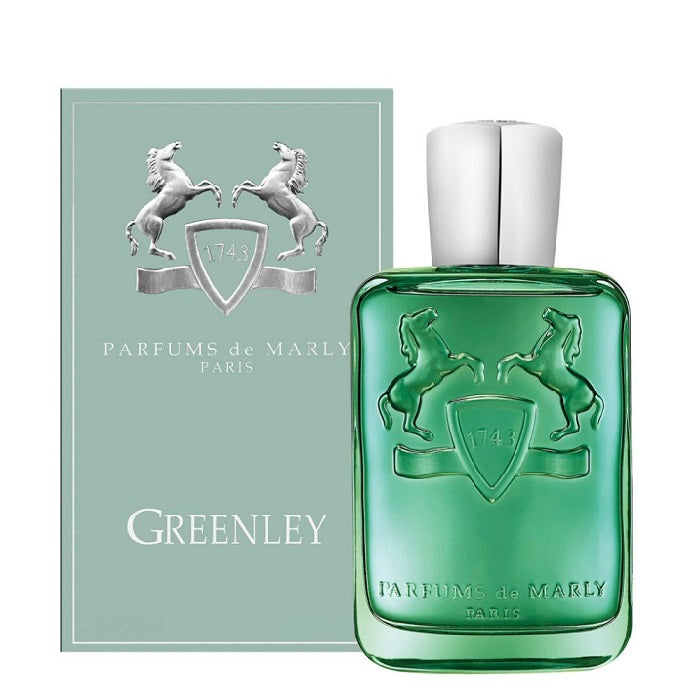Parfums de Marly Greenley perfume bottle in translucent green glass with a silver cap, shown next to its matching sage green box featuring a silver horse emblem.