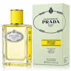 Prada Infusion D'Ylang Eau de Parfum bottle with a yellow cap next to its light green and yellow packaging box.