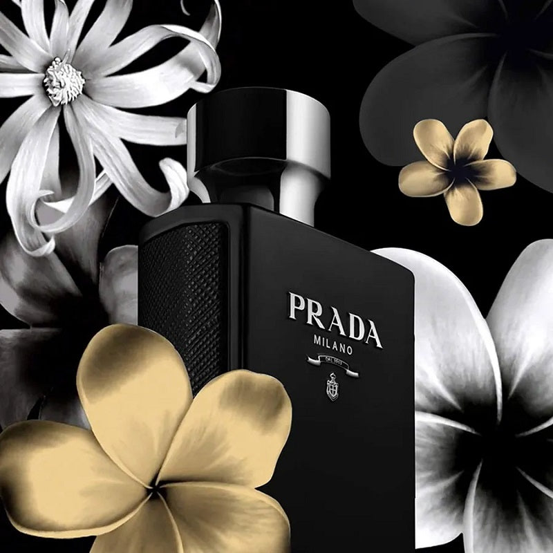 Prada Milano perfume bottle surrounded by flowers on a black background