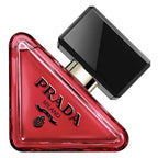 Prada Milano perfume bottle with a distinctive triangular red glass body and a glossy black rectangular cap, shown on a white background.