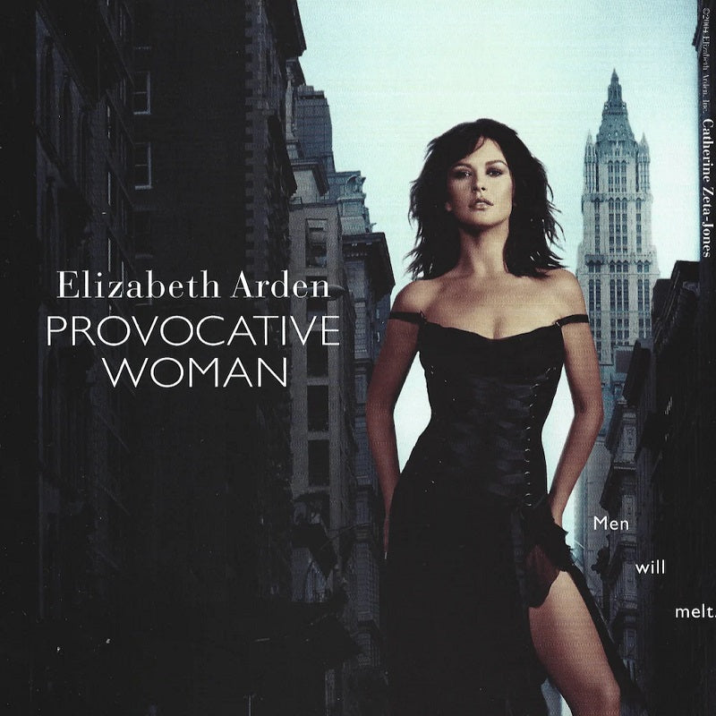 Advertisement for Elizabeth Arden Provocative Woman perfume with a woman in a black dress against a cityscape.