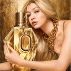Woman holding a gold perfume bottle with a luxurious background
