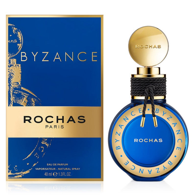 A product image featuring the Rochas Byzance Eau De Parfum by Rochas, with a blue bottle and gold details, alongside its packaging.