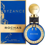 A product image featuring the Rochas Byzance eau de parfum in a blue bottle with gold details, next to its packaging.
