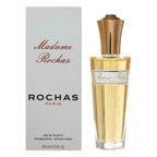A 100ml Eau de Toilette bottle of Madame Rochas by Rochas, with the product packaging visible. The bottle is clear with a gold-colored cap, and the label is white with red accents.
