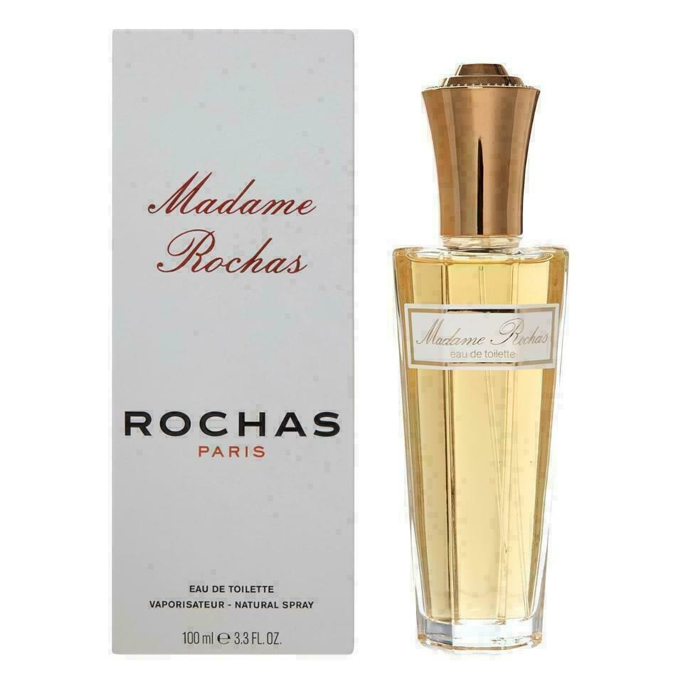 A 100ml Eau de Toilette bottle of Madame Rochas by Rochas, with the product packaging visible. The bottle is clear with a gold-colored cap, and the label is white with red accents.