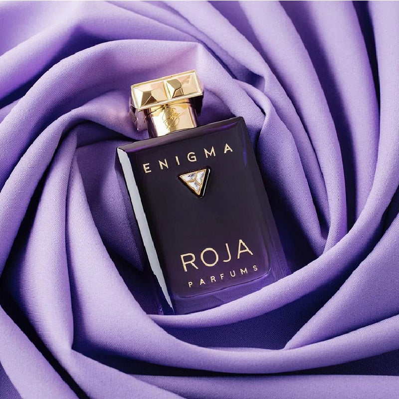 ROJA Parfums Enigma perfume bottle on purple fabric