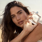 Woman holding a perfume bottle with a blurred background