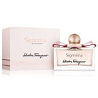 A product image featuring the Signorina Eau de Parfum by Salvatore Ferragamo, with the perfume bottle displayed in front of its packaging box. The bottle is clear with a gold cap, and the label has the name 'Signorina' on it.