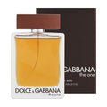 A bottle of Dolce & Gabbana 'The One for Men' Eau de Toilette with a wooden cap, positioned in front of its black and white packaging box.