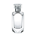 Clear perfume bottle with silver cap on a white background