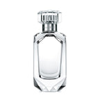 Clear perfume bottle with silver cap on a white background