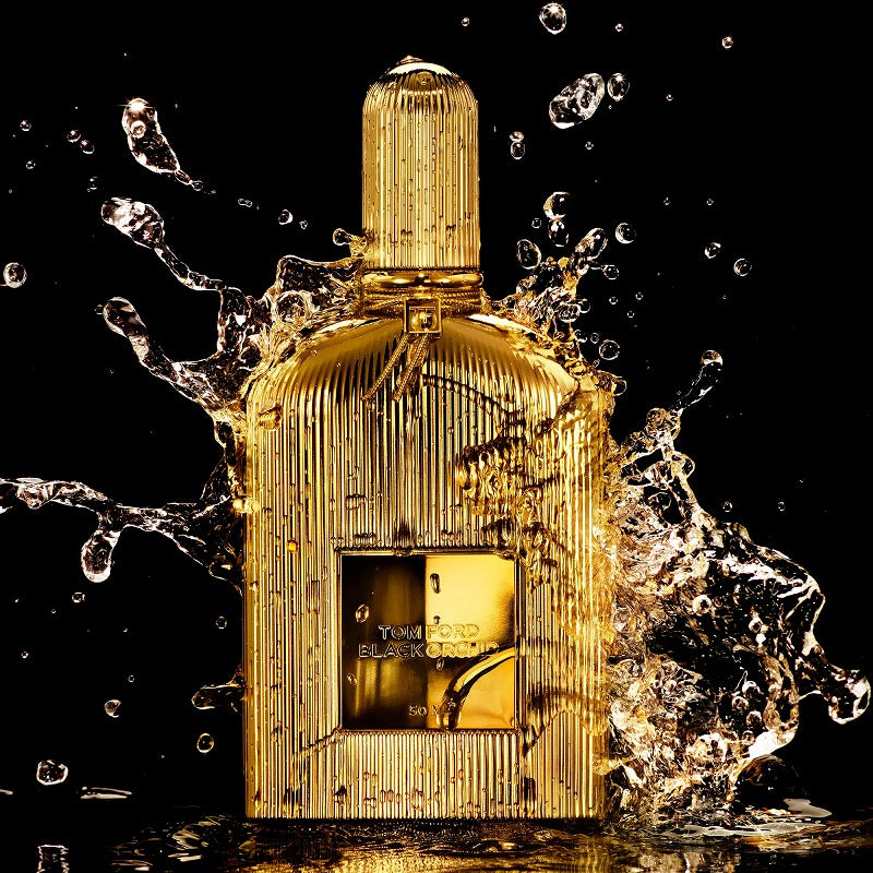 Gold bottle covered by water droplets on a black background