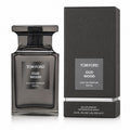 Tom Ford Oud Wood Eau de Parfum 100ml bottle in a dark smoky glass, shown next to its textured black packaging box on a white background.