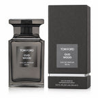 Tom Ford Oud Wood Eau de Parfum 100ml bottle in a dark smoky glass, shown next to its textured black packaging box on a white background.