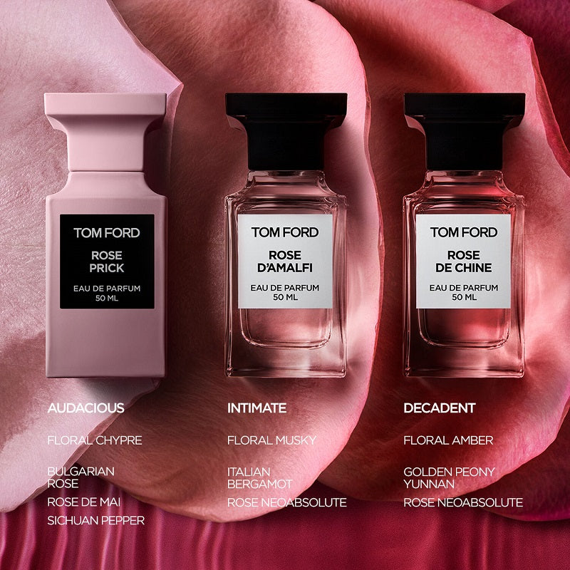 Three Tom Ford perfume bottles with labels on a pink and red floral background