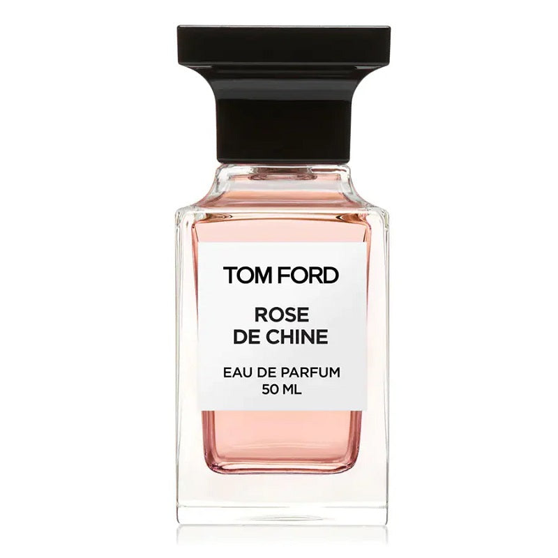 A clear glass bottle of Tom Ford Rose de Chine Eau de Parfum with a black cap and a white label.