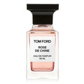 A clear glass bottle of Tom Ford Rose de Chine Eau de Parfum with a black cap and a white label.