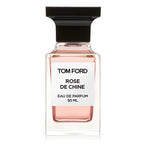 A clear glass bottle of Tom Ford Rose de Chine Eau de Parfum with a black cap and a white label.