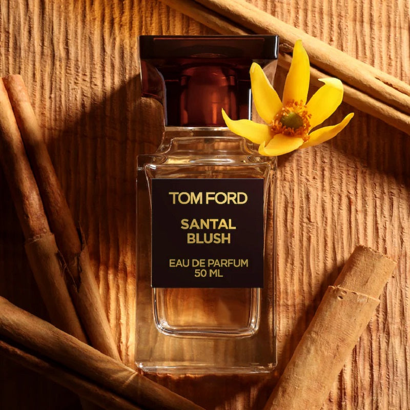 bottle of 50ml Santal Blush surrounded by ingredients against a bamboo background